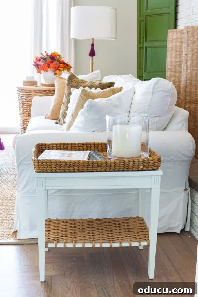 Embracing Autumn Hues in Your Living Space 12 White sofa and table in a living room decorated for fall, showcasing comfort and style with thoughtful autumnal touches.