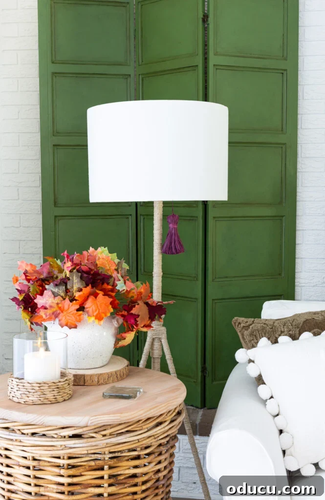 Embracing Autumn Hues in Your Living Space 4 Fall living room decor featuring a green paneled screen, subtle purple accents, and natural textures, creating a harmonious and inviting space.