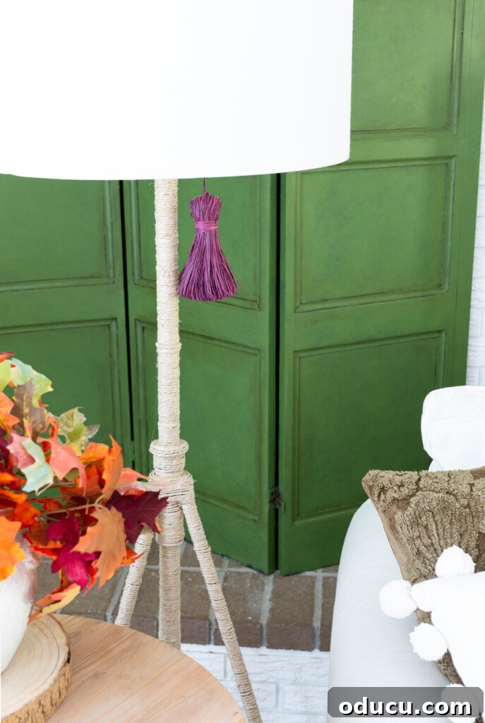 Embracing Autumn Hues in Your Living Space 5 Green wooden screen with a purple raffia tassel and a rope-wrapped floor lamp, showcasing a unique and colorful fall scheme.