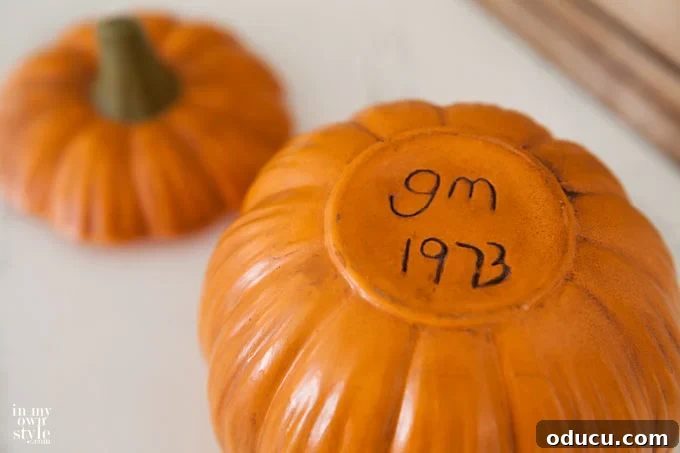 Embracing Autumn Hues in Your Living Space 10 Close-up of a vintage ceramic pumpkin, a sentimental fall decoration crafted by hand.