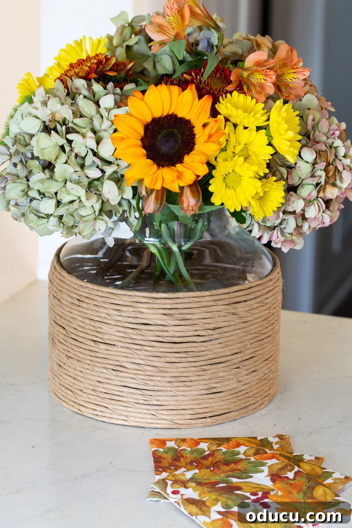 fall flowers in paper cord wrapped vase