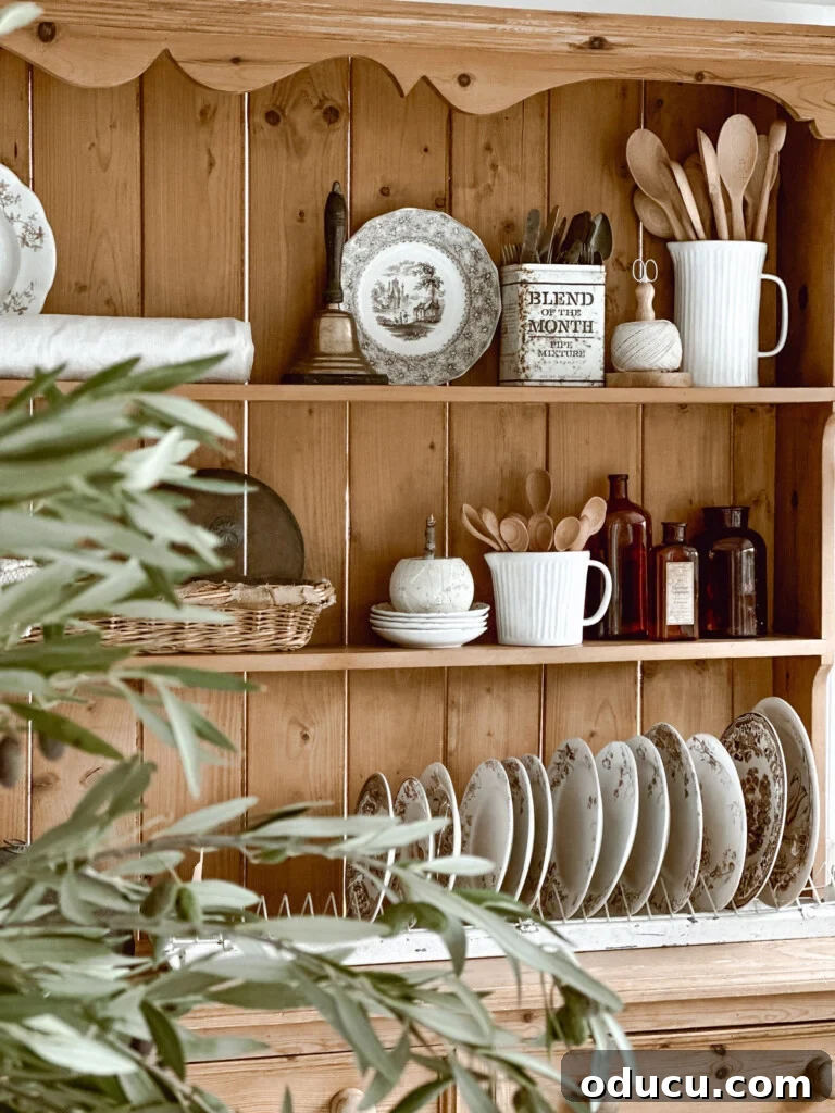 Trend Spotting Volume 114 2 A charming pine hutch beautifully adorned for autumn, featuring elegant brown and white Transferware, pumpkins, and rustic touches.