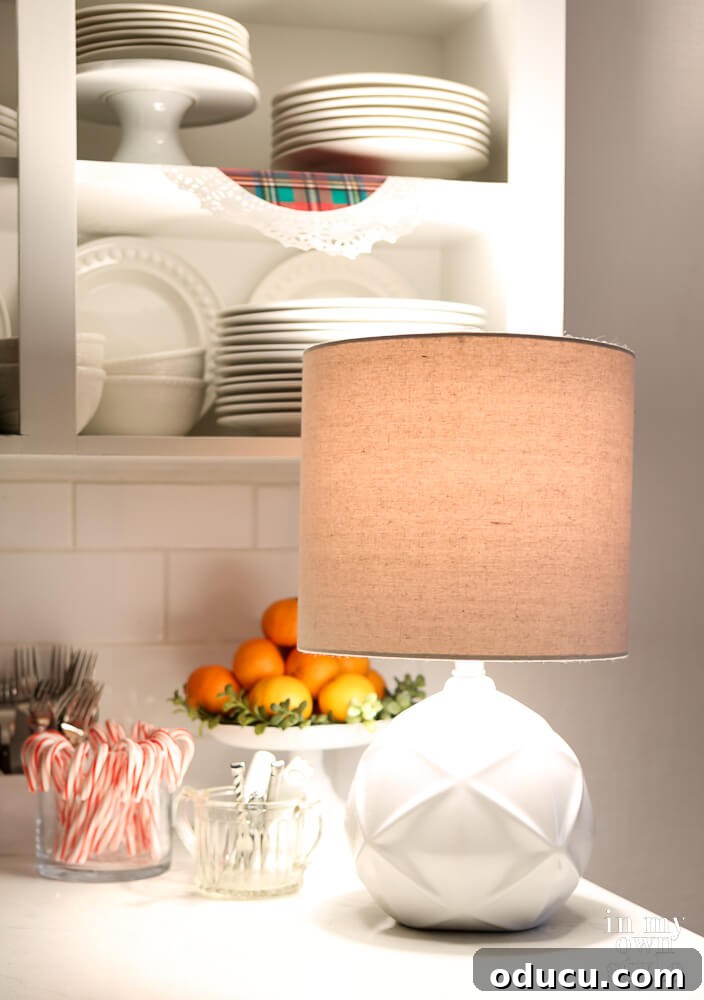 A small, elegant lamp placed on a kitchen counter, providing soft, warm light and enhancing the cozy ambiance.