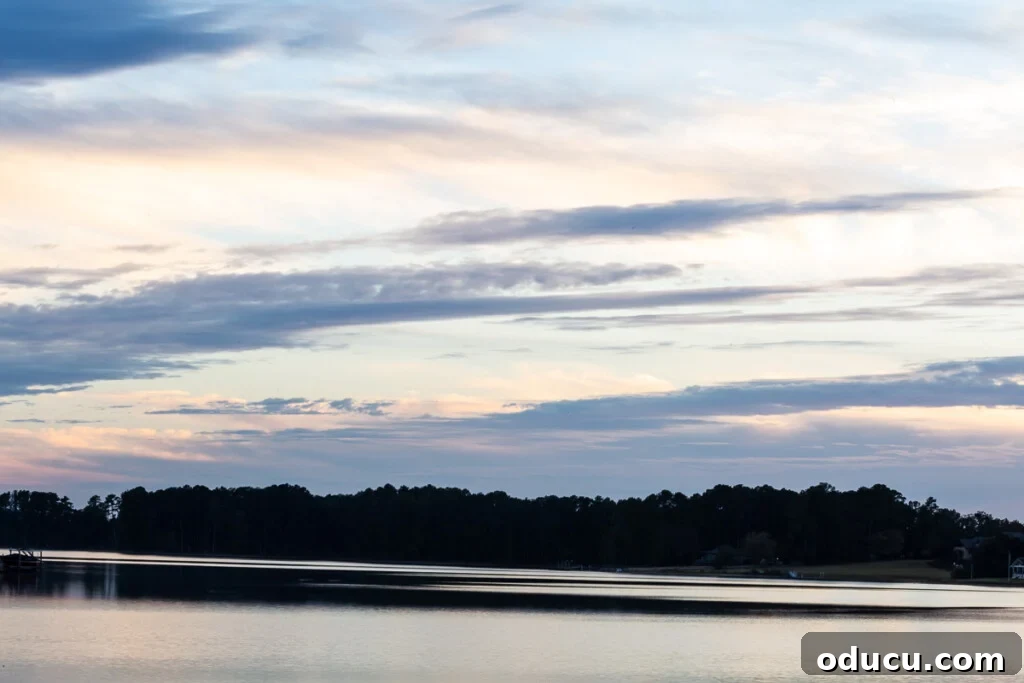 Cozy Fall Home Challenge 6 Vibrant sunset over a tranquil lake, showcasing a sky ablaze with shifting colors and cloud patterns, a perfect backdrop for a peaceful evening.