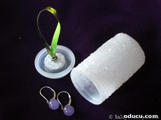 Craft 15 Beautiful Christmas Ornaments You'll Cherish 17 Glitter-covered film canister repurposed into a Christmas ornament with a hidden gift.