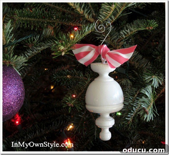 Craft 15 Beautiful Christmas Ornaments You'll Cherish 18 Wood curtain rod finial repurposed into a stylish Christmas tree ornament, painted pink and white.