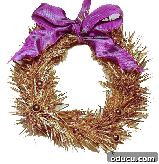 Craft 15 Beautiful Christmas Ornaments You'll Cherish 19 Mini wreath ornament, spray painted gold and adorned with a purple ribbon bow.