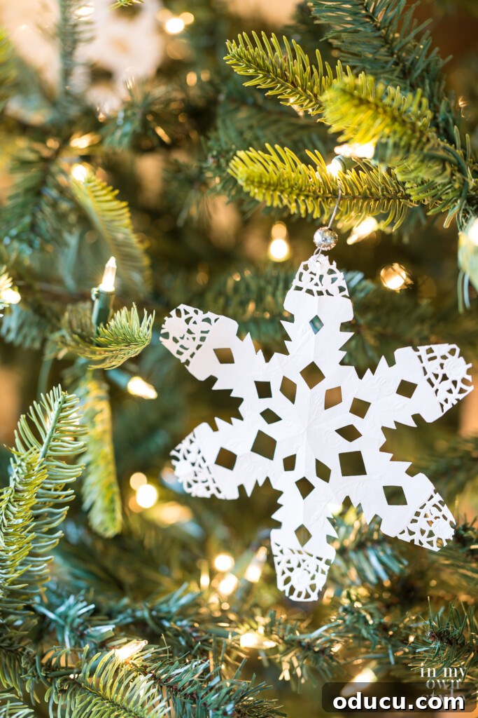 Craft 15 Beautiful Christmas Ornaments You'll Cherish 6 Paper doily crafted into a beautiful snowflake Christmas tree ornament.