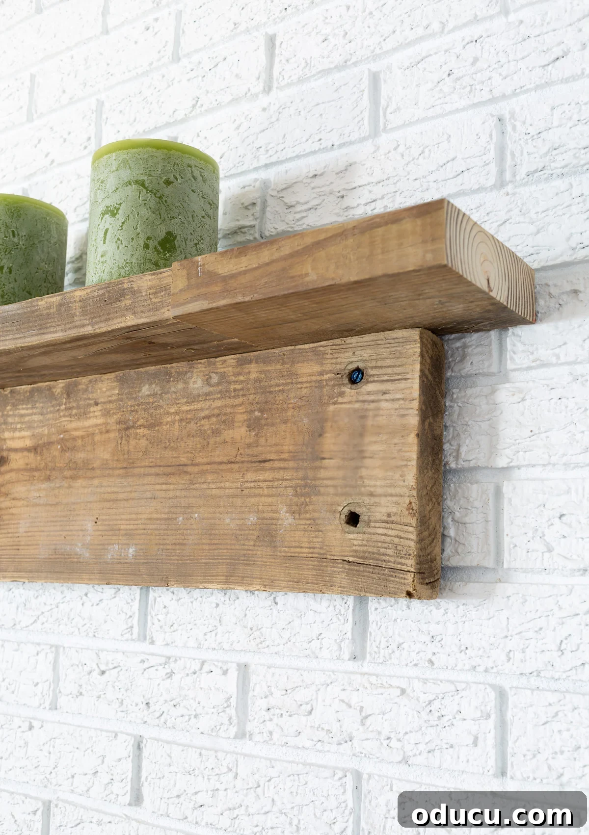 close up side view of DIY fireplace mantel made with two reclaimed wood boards.