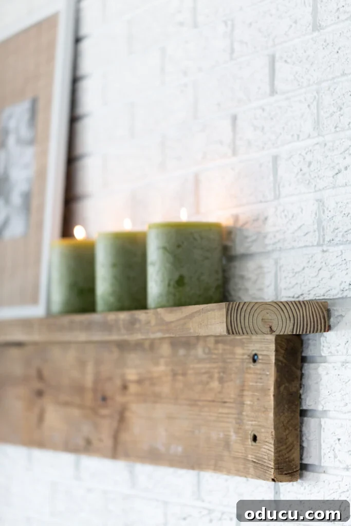 Effortless DIY Fireplace Mantel 6 3 green pillar candles in DIY rustic wood mantel