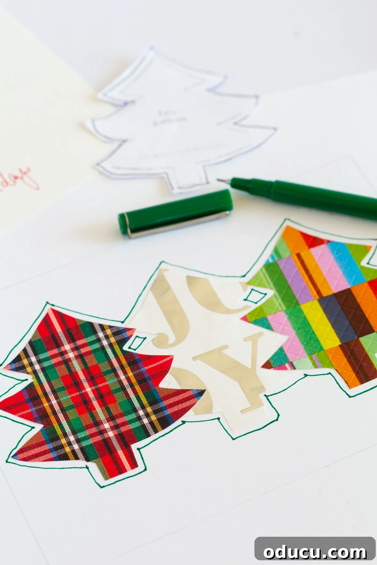 outline the cutout gift wrap trees on card.