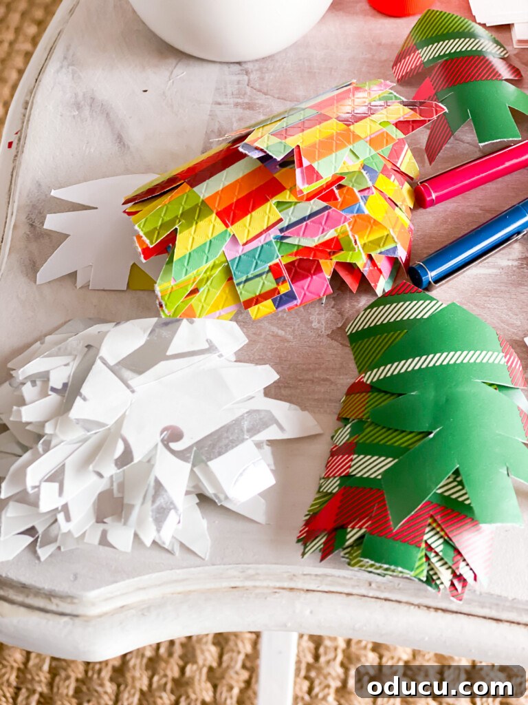 Cut out Christmas tree shapes from holiday gift wrap