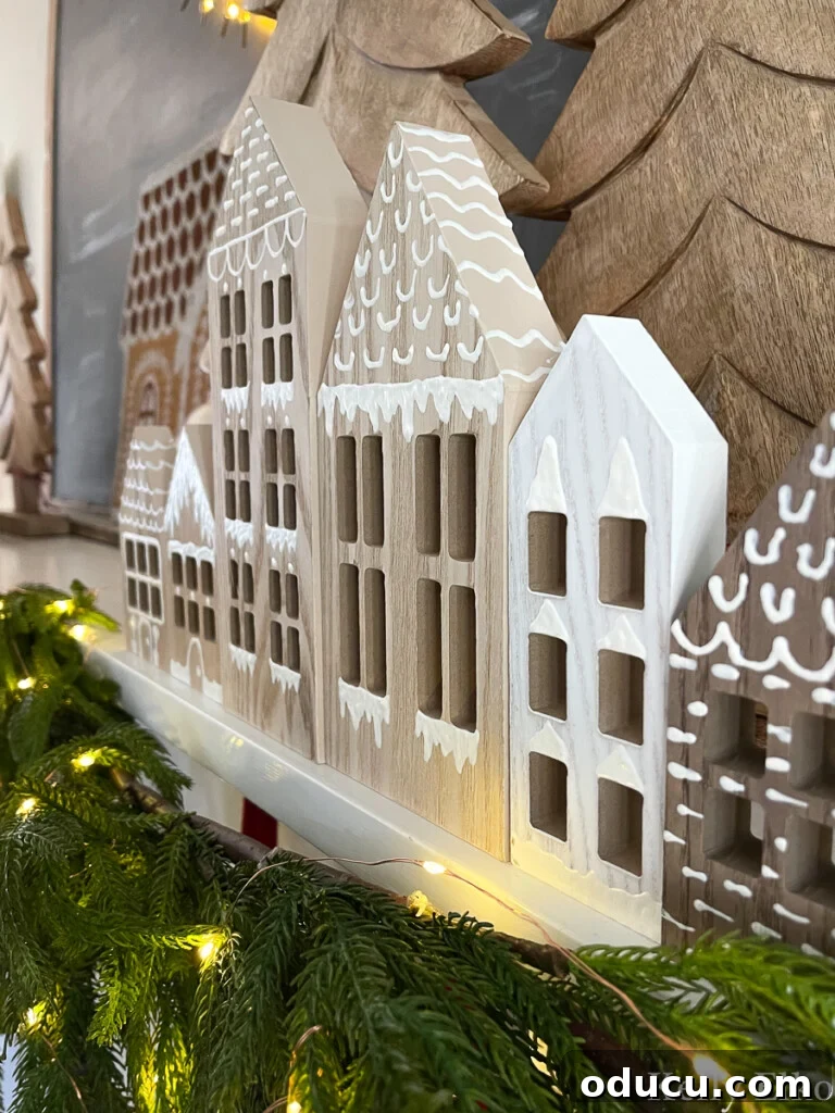 Chic Chronicles Issue 121 2 Charming DIY wooden gingerbread houses arranged elegantly on a festive Christmas mantelpiece, exuding rustic holiday cheer.