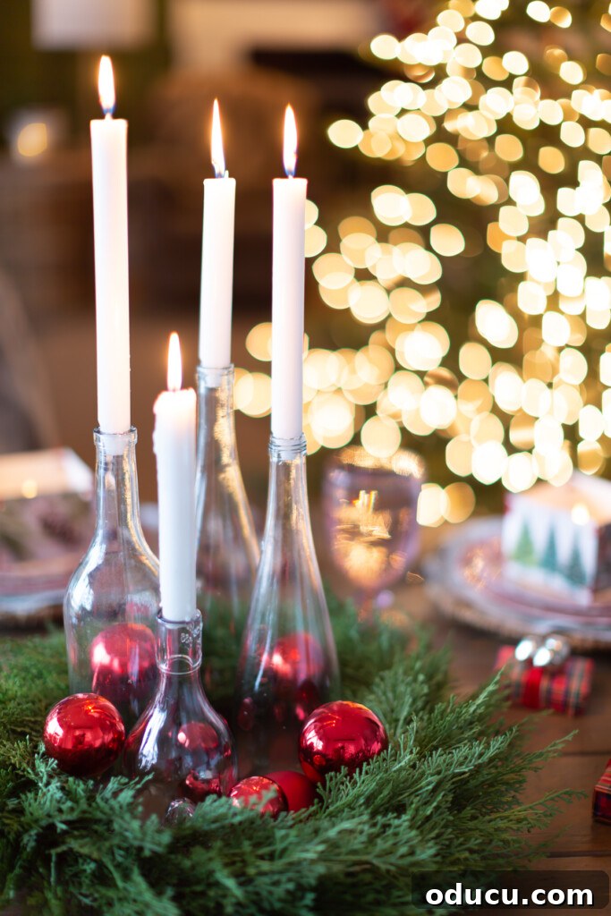 White candles in clear bottles become a budget Christmas dinner table centerpiece.