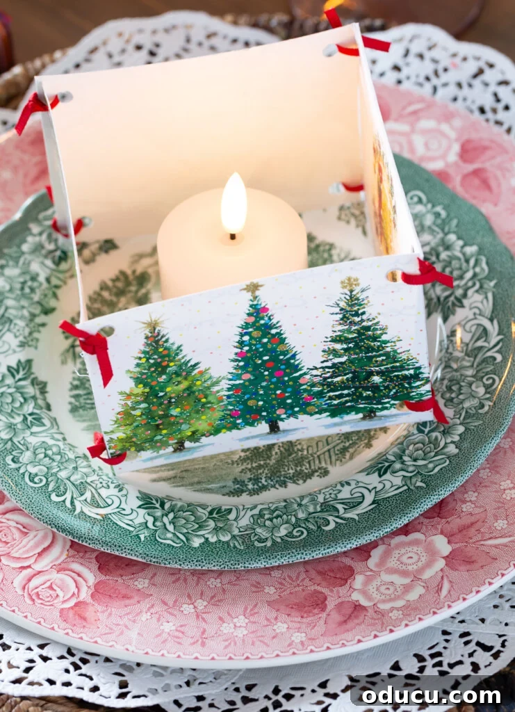 Candle placed inside a box made of old Christmas cards