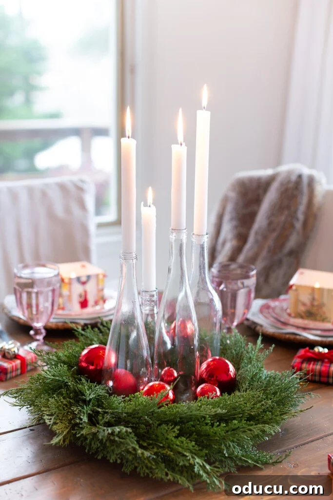 DIY clear bottle candle table centerpiece for Christmas dinner table setting.