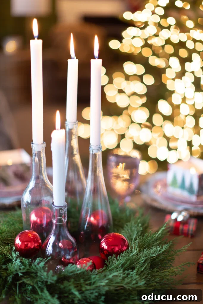 White candles in clear bottles become a budget Christmas dinner table centerpiece.