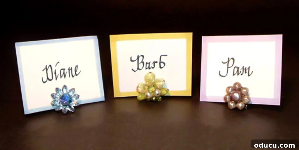 Repurpose Your Jewelry for Home Decor 10 Three elegant place cards, each featuring a vintage clip-on earring as a unique and charming place card holder.