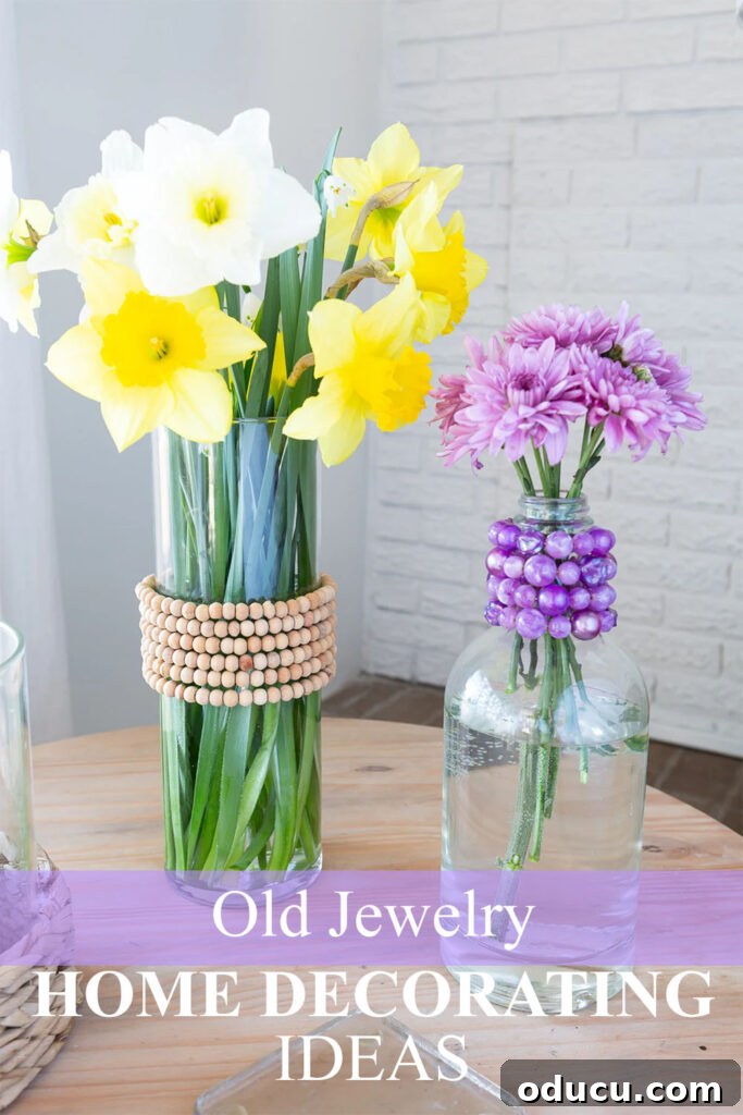 Repurpose Your Jewelry for Home Decor 14 Two beautiful glass vases, elegantly decorated with repurposed old jewelry, showcasing creative home decor.