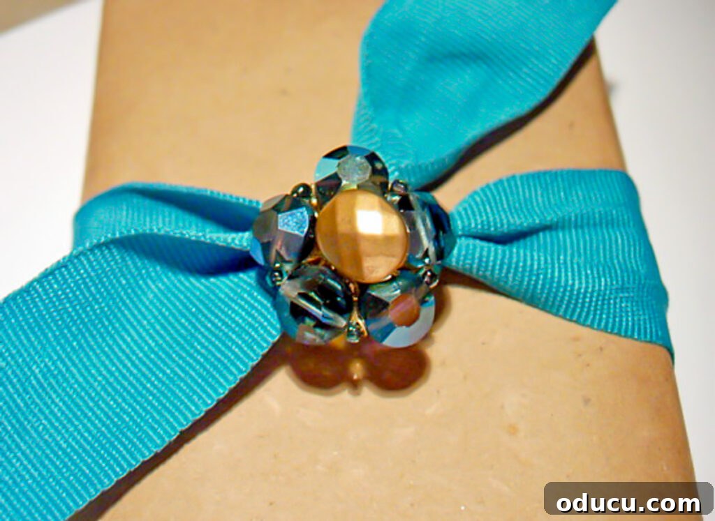 Repurpose Your Jewelry for Home Decor 9 A beautifully wrapped gift with turquoise ribbon and a sparkling glass bead vintage clip-on earring as an elegant embellishment.
