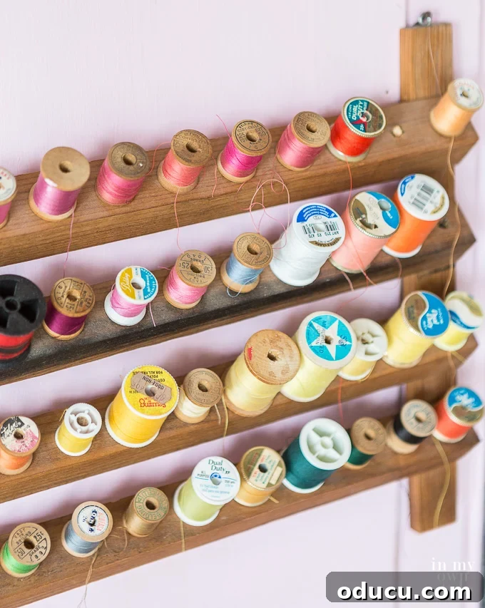 31 Clever & Chic Craft Room Ideas 23 Hanging organizer for spools of thread in a craft room