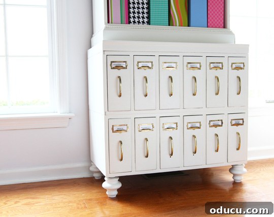 31 Clever & Chic Craft Room Ideas 30 White chalk painted cabinet in a craft room, part of a combined furniture setup