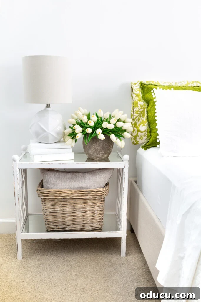 Christeli Charleston Mattress: What You Need to Know 2 White and green guest room - bed and night table with lamp and vase of tulips