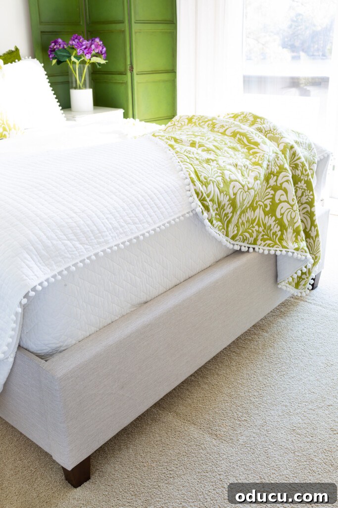 Christeli Charleston Mattress: What You Need to Know 14 Christeli mattress in an Eastman platform bed with white bedding and a green and white throw blanket
