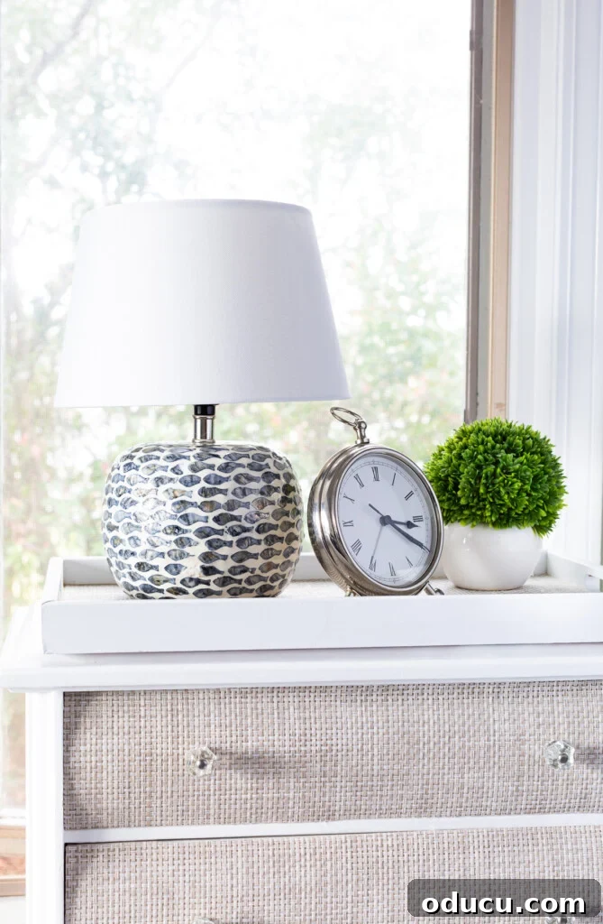 The Curious Case of My Lamp's Little Lift 5 table lamp on night table with clock and greenery