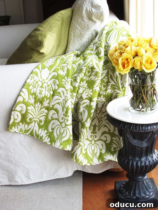 Revitalize Your Bedroom: Creative Decor Transformations 3 A beautifully crafted throw blanket, showcasing a patterned fabric, draped over furniture, with a caption indicating how to make it.