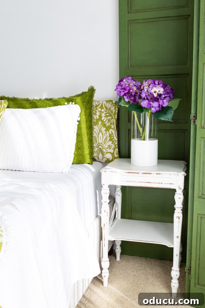 Revitalize Your Bedroom: Creative Decor Transformations 10 A charming green and white guest room, thoughtfully decorated with subtle purple accents, creating a harmonious and inviting space.