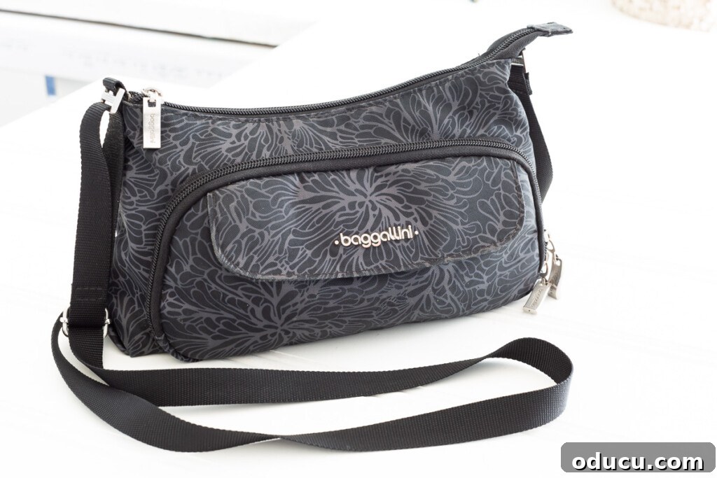 Friday Fun Bag Dump 3 The sleek and functional Baggallini Crossbody handbag, affectionately known as The Everyday Bagg, showcasing its compact yet spacious design.
