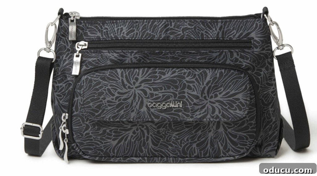 Friday Fun Bag Dump 8 A clear image showcasing The Original Everyday Bagg by Baggallini, highlighting its distinctive features and slightly larger, more square silhouette.