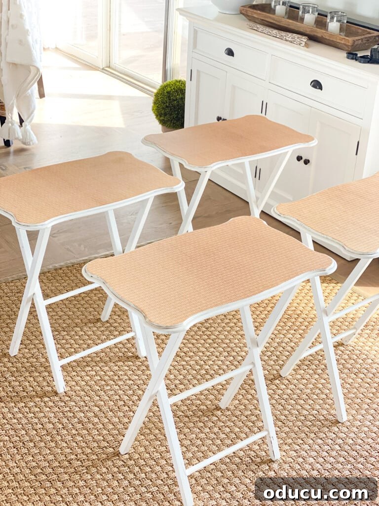 Decoupage Furniture Made Simple Your Visual Step by Step 17 a set of 4 wood tray tables in a living room showing how nice they look after getting a makeover using wallpaper.