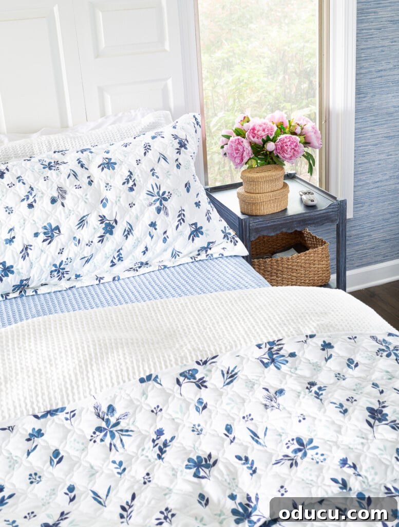 Bedroom Blooms: Your Instant Spring Refresh 2 A beautifully made bed with blue and white floral bedding, suggesting comfort and style.