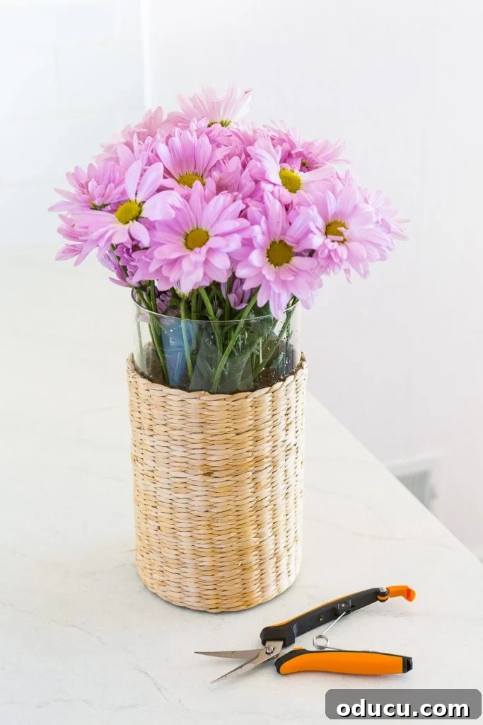Pink Flowers in Wicker and Glass Vase Pink flowers in a wicker and glass vase.