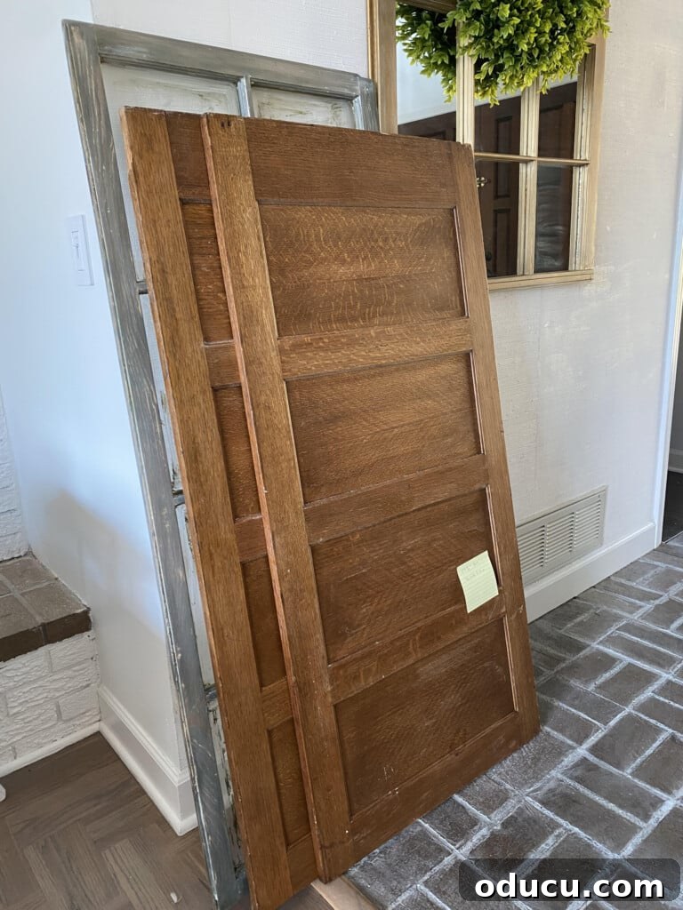 Found Treasure: My Living Room's Fireplace Cover 2 Two sturdy wood panels from an old file cabinet, reclaimed and ready for a DIY project, leaning against a neutral wall.