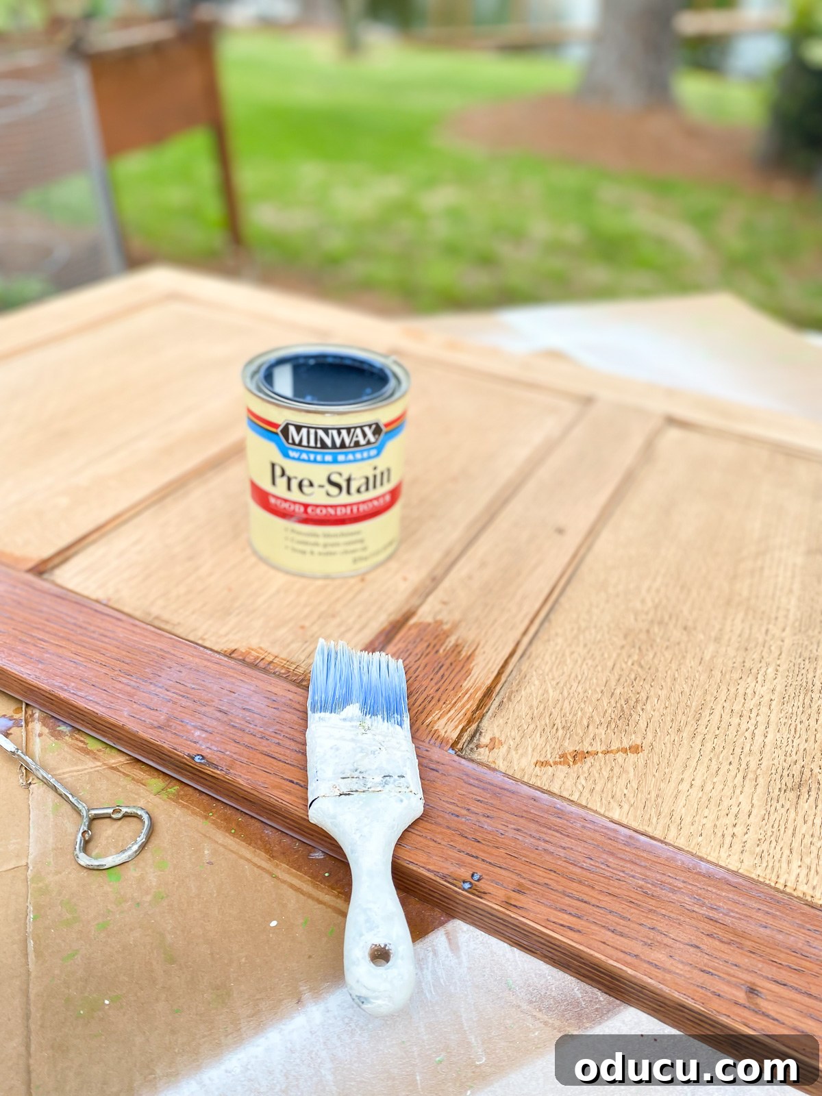 Found Treasure: My Living Room's Fireplace Cover 9 Brushing Minwax Water Based Pre-Stain on recessed panels from the sides of a old file cabinet, preparing them for a new finish.