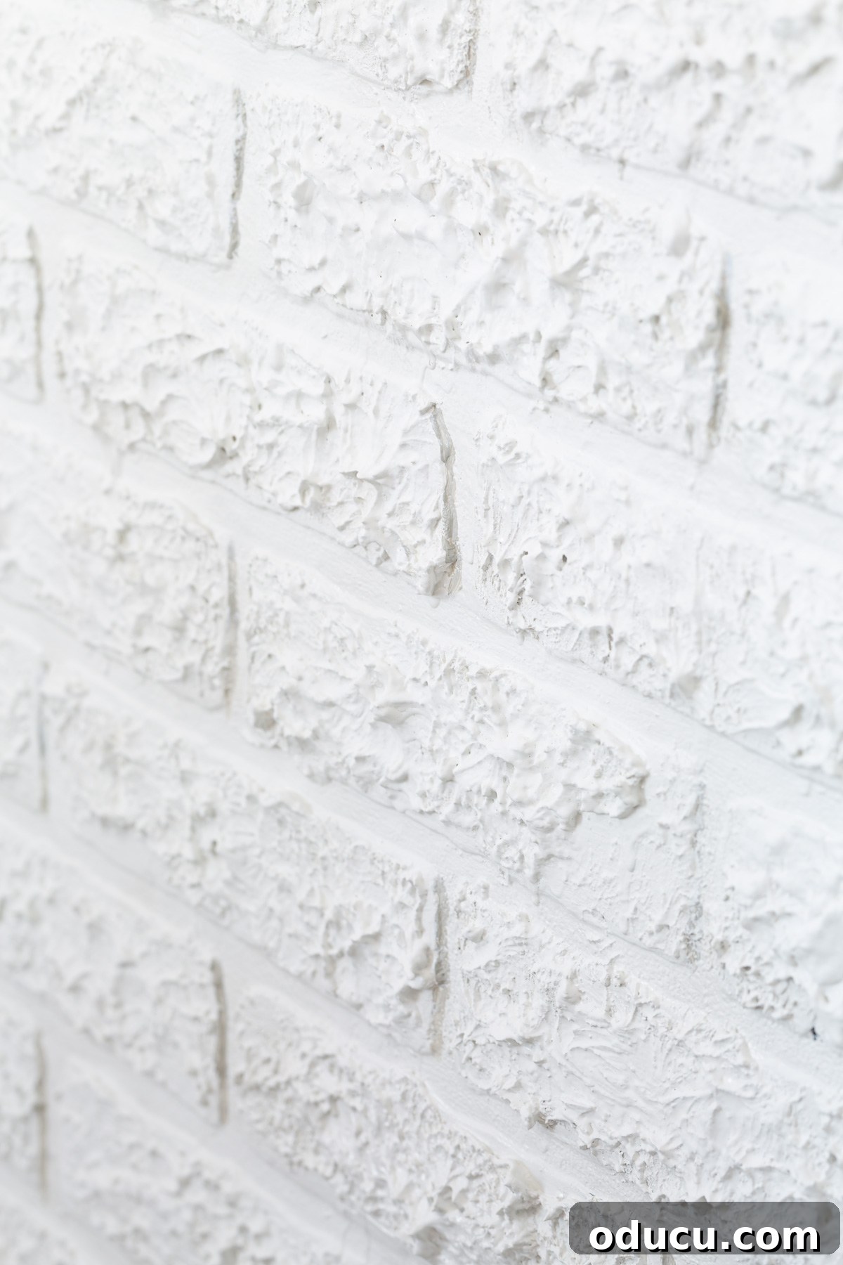 Instant Brick Wall: DIY with Faux Panels from Your Local Store 12 Close up of faux brick paneling with spackle added to provide texture to match brick wall around it, showing painted shadows.
