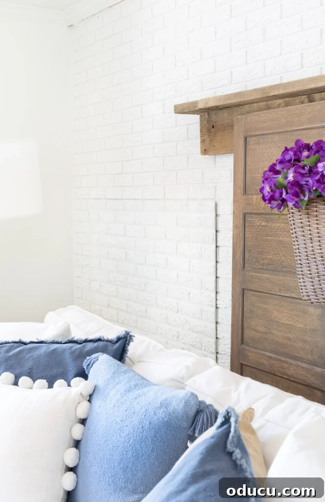 Instant Brick Wall: DIY with Faux Panels from Your Local Store 7 Side view of faux brick paneling used to cover up a firewood storage area for the summer, blending into a brick accent wall in a living room.