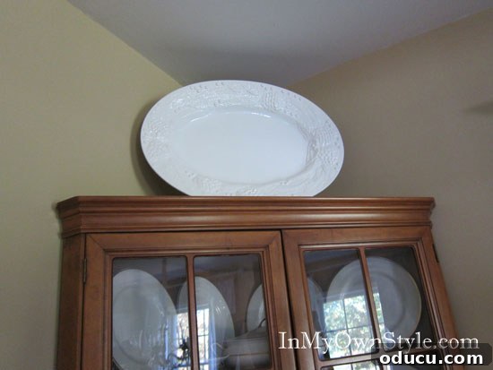 How to add height to decorative items on top of wall cabinets and hutches. Clever ways to add height to decorative items on cabinet tops