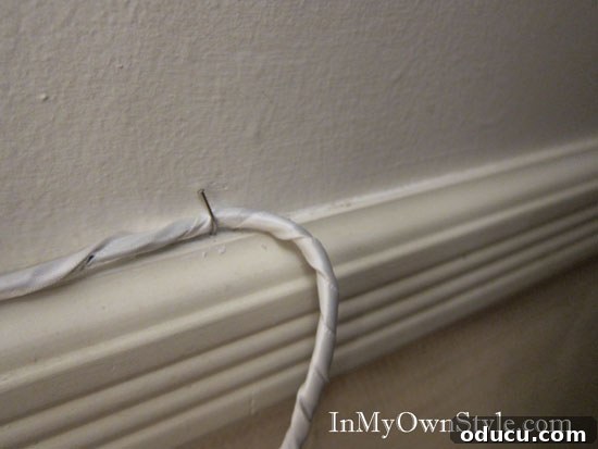 Hanging Cord and wire hiding trick Hiding the end of a wrapped cord behind furniture for easy access