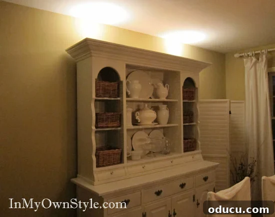 How to add lighting to the top of a dining room china cabinet Dining room hutch with can lights and decorative string lights on