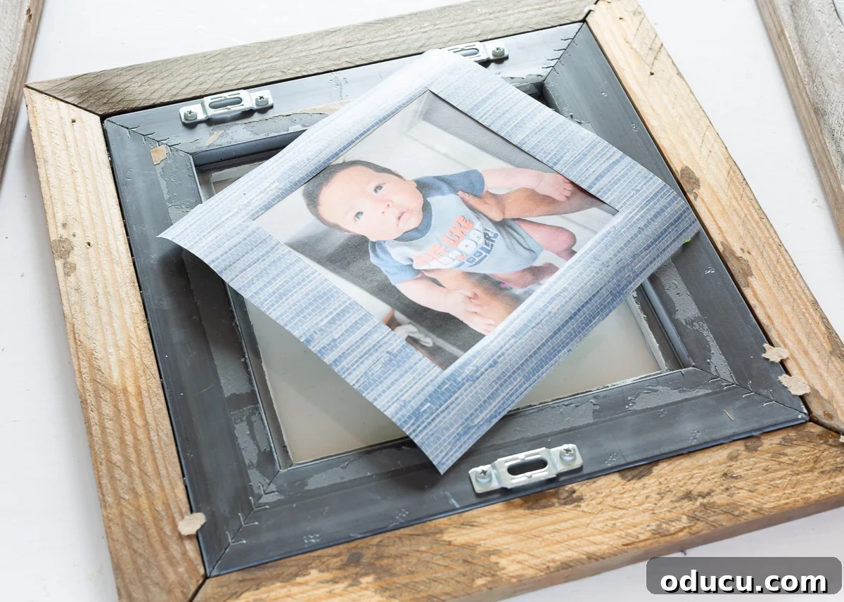 A DIY photo frame mat idea using wallpaper, showcasing the layering of glass, mat, photo, and cardboard backing.