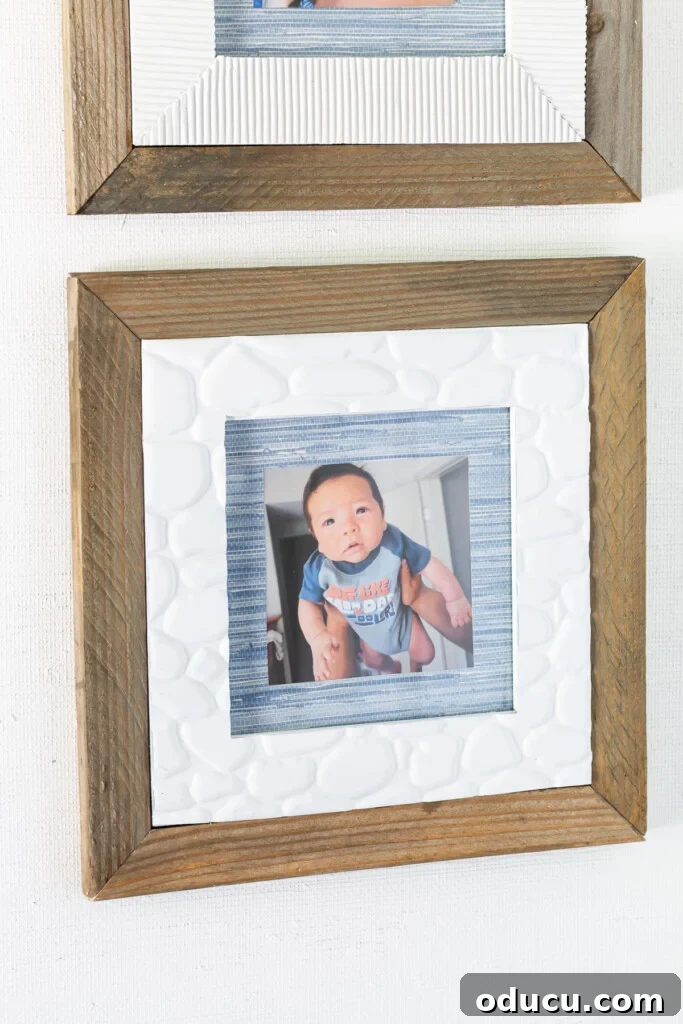 Scrap wood framed thrift store frame makeover idea that also uses wallpaper scraps and faux stone adhesive tile from the Dollar Tree, showcasing a harmonious blend of textures.