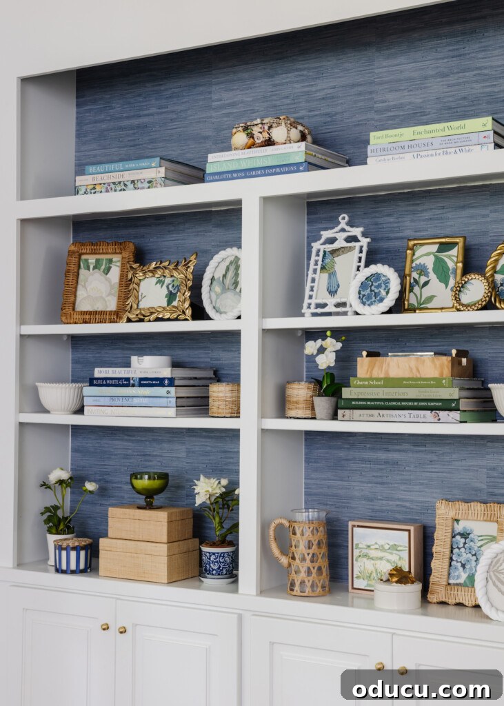 Style Scouting: Milestone 150 2 white shelving unit with blue grasscloth paper behind it