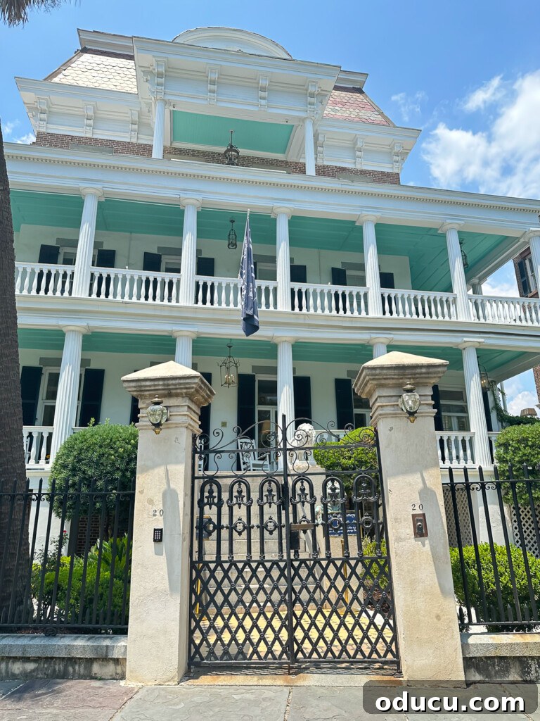 a teal and white historic southern mansion overlooking the harbor in Charleston