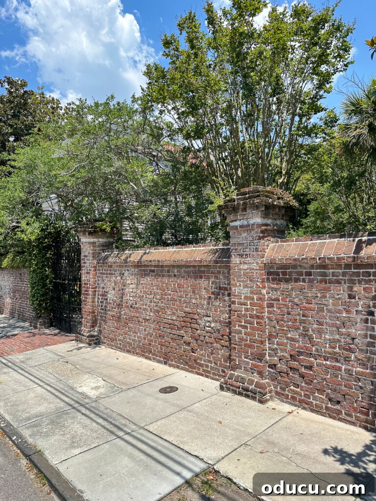 ornate brick wall along sidewalk in Charleston, SC