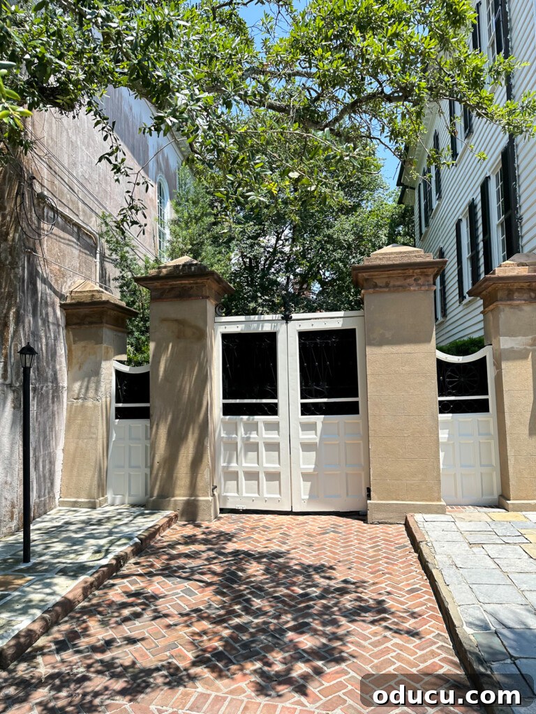 White wood driveway door flanked by stucco square columns.