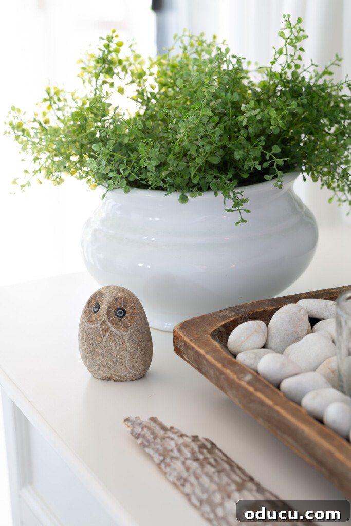 Creating a Cozy Fall Living Room Sanctuary 15 Stone owl and decorative accessories on a sideboard.